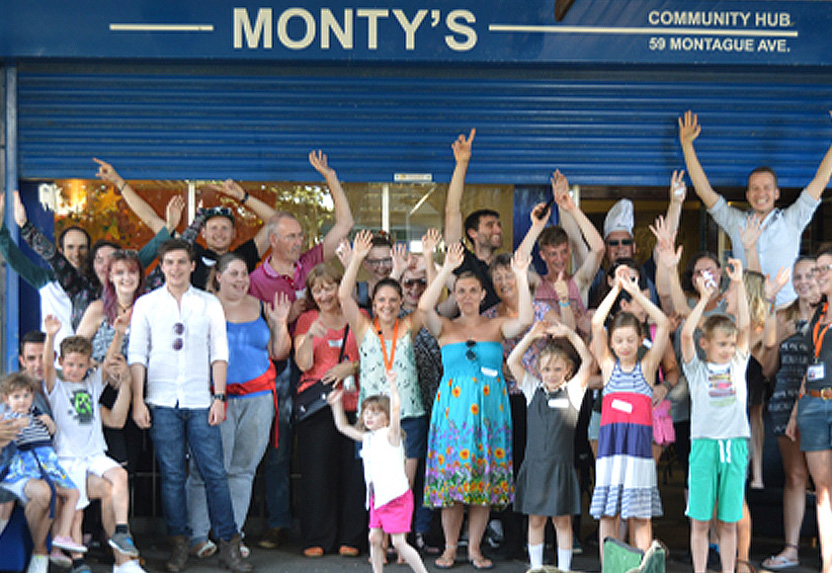 A group of people of all ages outside Monty's Community Hub